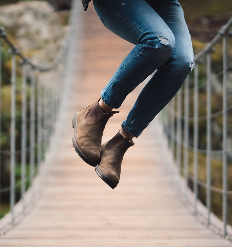 women jumping in blundstone boots